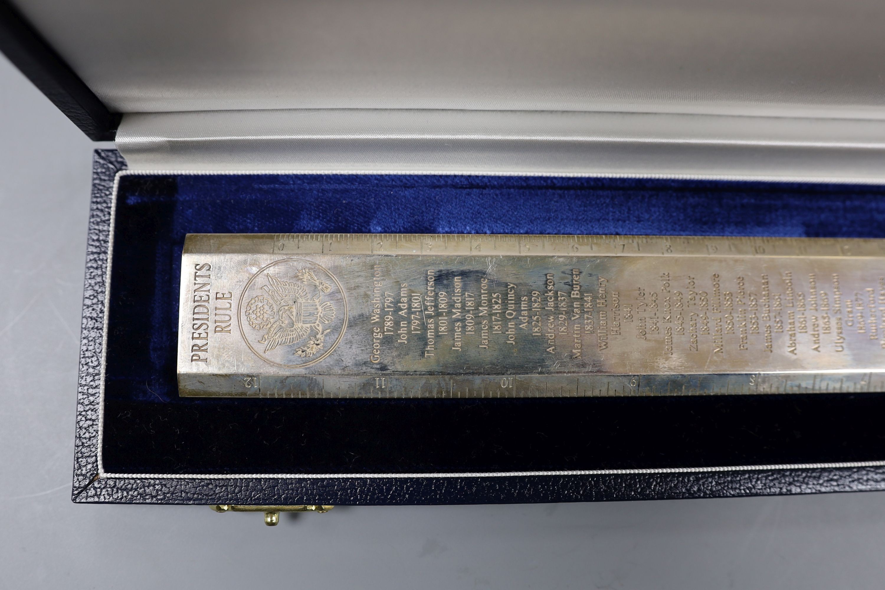 A cased modern silver 'Presidents Rule' ruler, engraved with the names and dates of US Presidents, by Richard Jarvis, London, 2004, 10oz